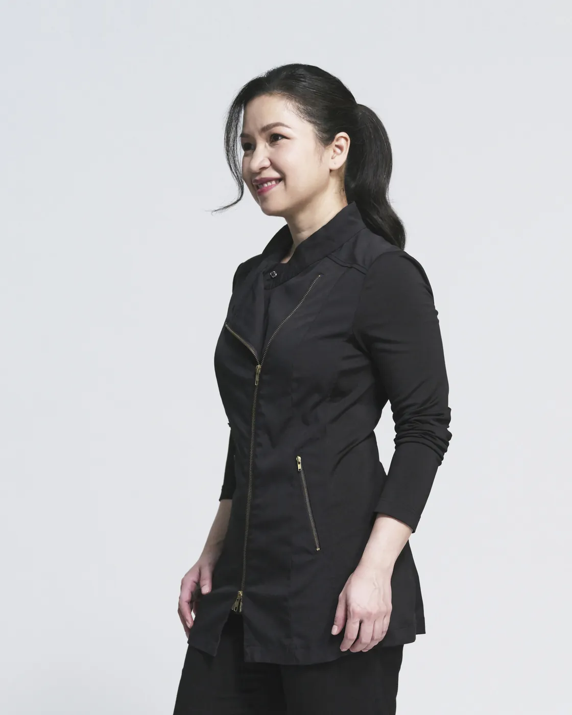 Dr Chang Fu Shi in her clinical tunic, looking to one side